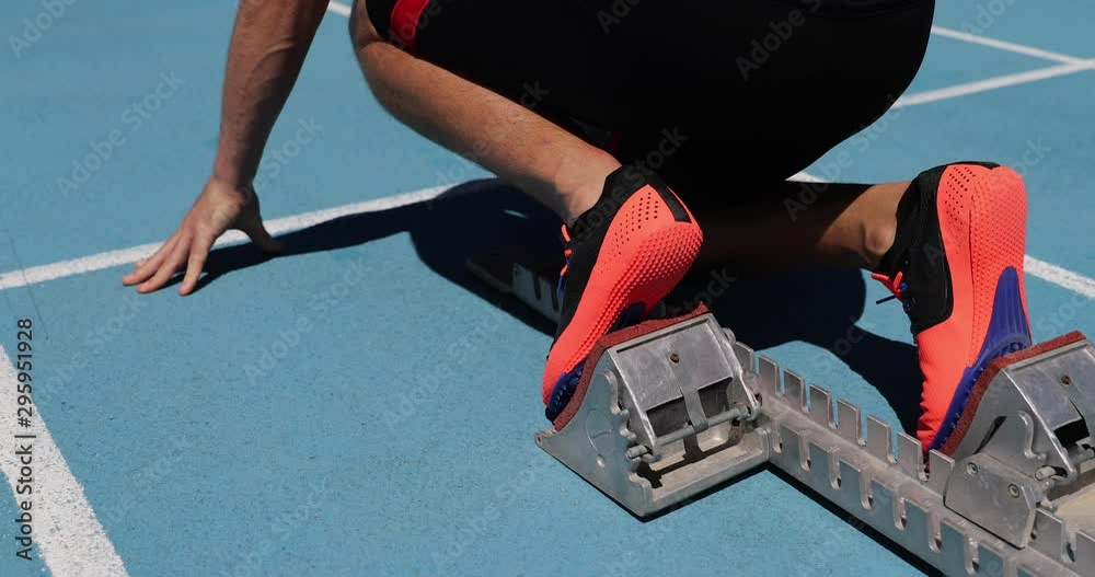Runner ready to run on running track start line starting blocks. Sport ...