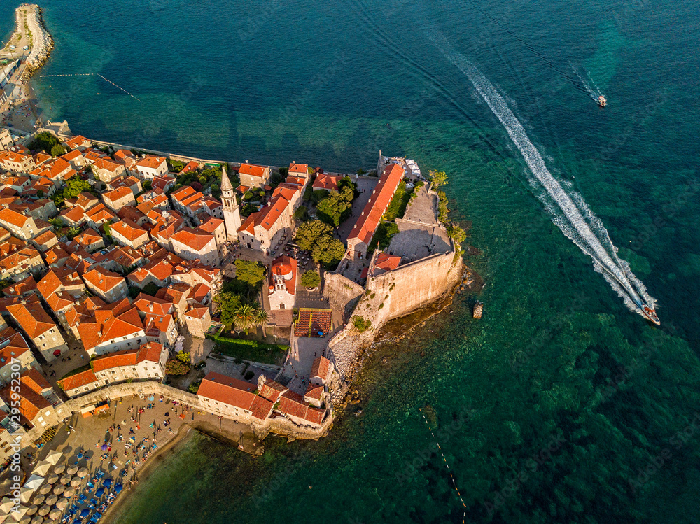 Aerial view of Budva, the old city (stari grad) of Budva, Montenegro. Jagged coast on the Adriatic Sea. Center of Montenegrin tourism, well-preserved medieval walled city, sandy beaches