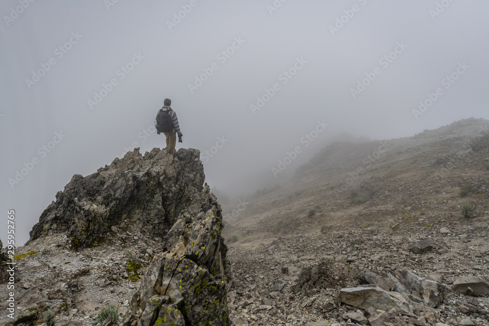 Man on top of mountain, seeing the beautiful fog landscape, Mexican landscape, Nevado de Toluca, Mexico.