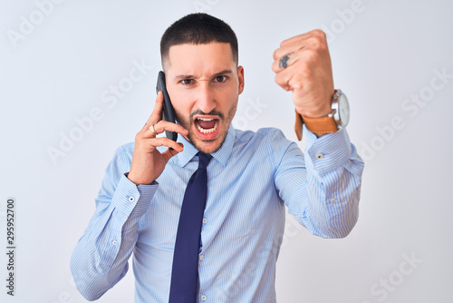 Young handsome business man calling using smartphone over isolated background annoyed and frustrated shouting with anger, crazy and yelling with raised hand, anger concept