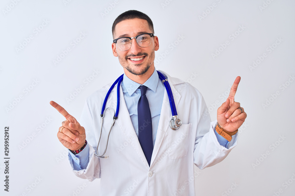 Young doctor man wearing stethoscope over isolated background smiling confident pointing with fingers to different directions. Copy space for advertisement Young doctor man wearing stethoscope over isolated background smiling confident pointing with fingers to different directions. Copy space for advertisement