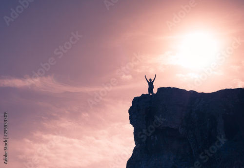 Man celebrating on top of a mountain. Victory and overcoming adversity. 