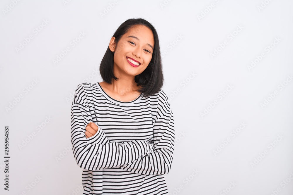 Konstfotografi Young chinese woman wearing striped t-shirt standing over isolated white background happy face smiling with crossed arms looking at the camera
