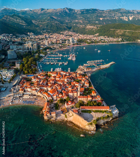 Aerial view of Budva, the old city (stari grad) of Budva, Montenegro. Jagged coast on the Adriatic Sea. Center of Montenegrin tourism, well-preserved medieval walled city, sandy beaches © Naeblys