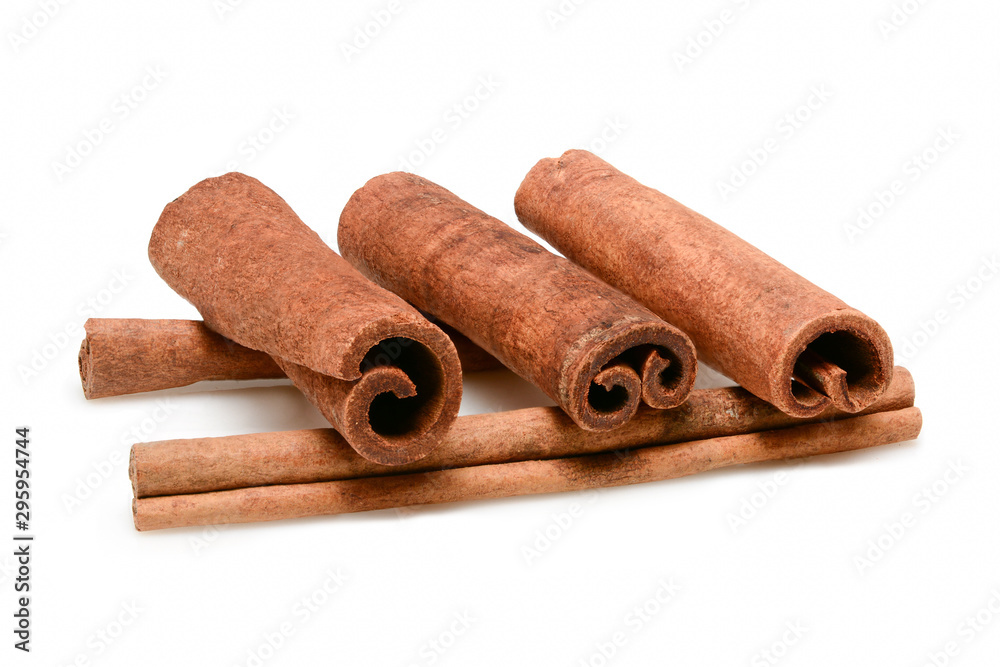 Cinnamon sticks for cooking and cosmetics. Five sticks close up macro isolated on white background with shadow. Full depth of field, high resolution. Cinnamon sticks for cooking and cosmetics. Five sticks close up macro isolated on white background with shadow. Full depth of field, high resolution.