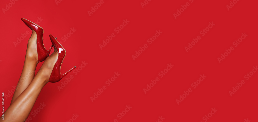 Εκτύπωση καμβά Beautiful long legs in red high heels with a copy space in the background