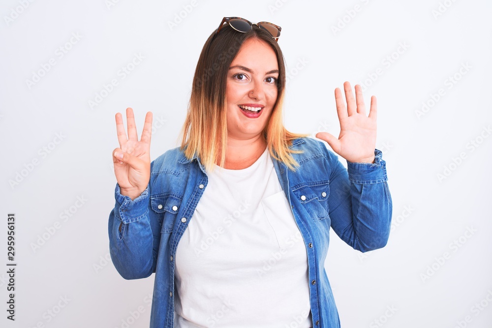 Beautiful woman wearing denim shirt standing over isolated white background showing and pointing up with fingers number eight while smiling confident and happy. Beautiful woman wearing denim shirt standing over isolated white background showing and pointing up with fingers number eight while smiling confident and happy.