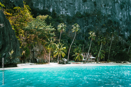 El Nido, Palawan, Philippines. Secluded tropical hut on Pinagbuyutan Island. Amazing white sand beach,turquoise blue lagoon water and palm trees