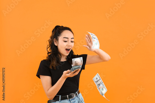 Asian woman throwing money ...
