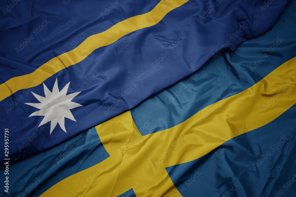 waving colorful flag of sweden and national flag of Nauru . waving colorful flag of sweden and national flag of Nauru .