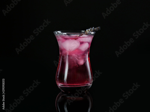 Glass of tasty cocktail on dark background