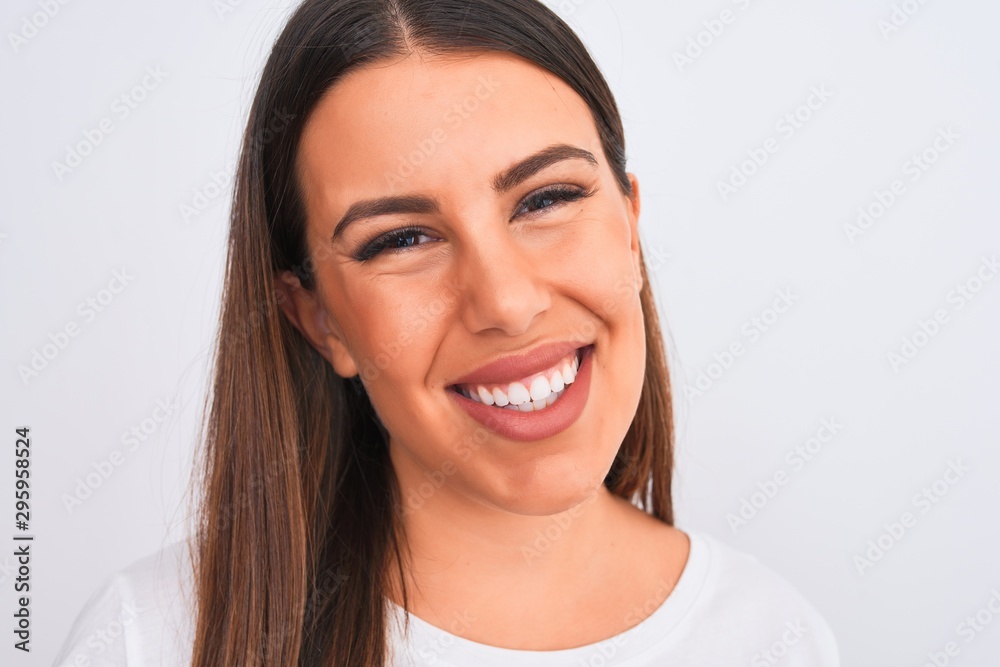 Close up of beautiful and young brunette woman standing over isolated white background with a happy face standing and smiling with a confident smile showing teeth Close up of beautiful and young brunette woman standing over isolated white background with a happy face standing and smiling with a confident smile showing teeth