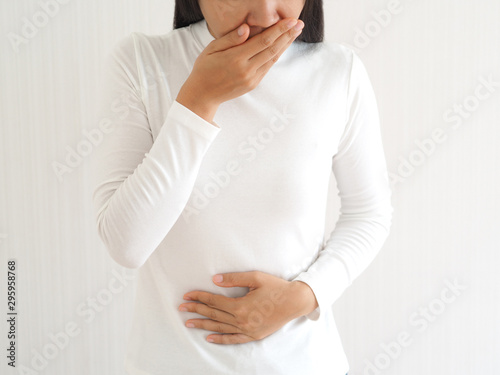 woman vomiting and nausea on isolated white background use for health care concept. photo
