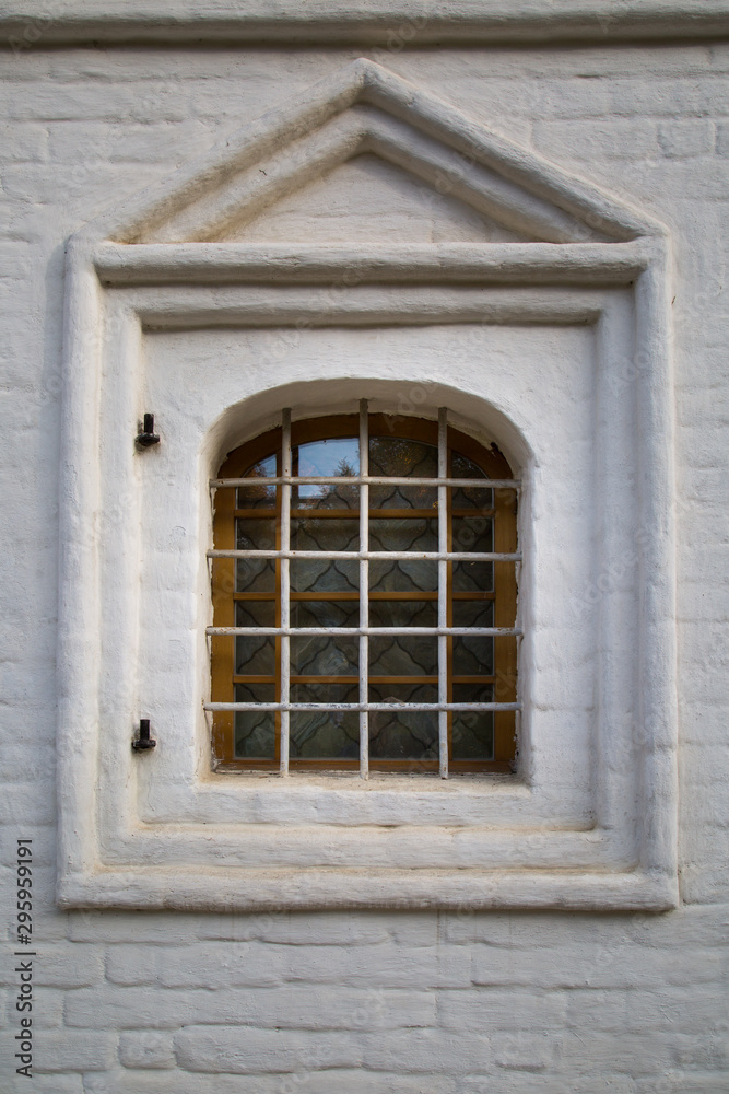 The look of the old Windows with ornate metal bars, a beautiful decorative finish on the outside with a brick. Architecture, elements, the style of the middle ages.