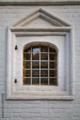 The look of the old Windows with ornate metal bars, a beautiful decorative finish on the outside with a brick. Architecture, elements, the style of the middle ages. © Victor1153