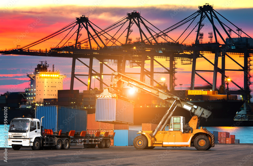 The cargo ship industry is parked in a harbor with a large crane bridge, transporting goods, importing and exporting trucks