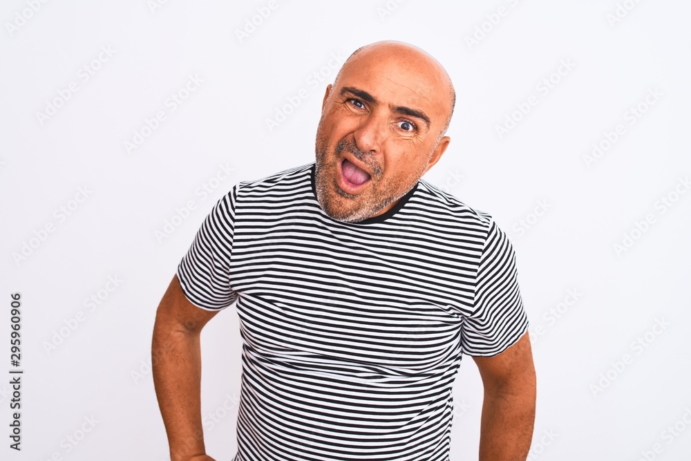 Middle age handsome man wearing striped navy t-shirt over isolated white background In shock face, looking skeptical and sarcastic, surprised with open mouth