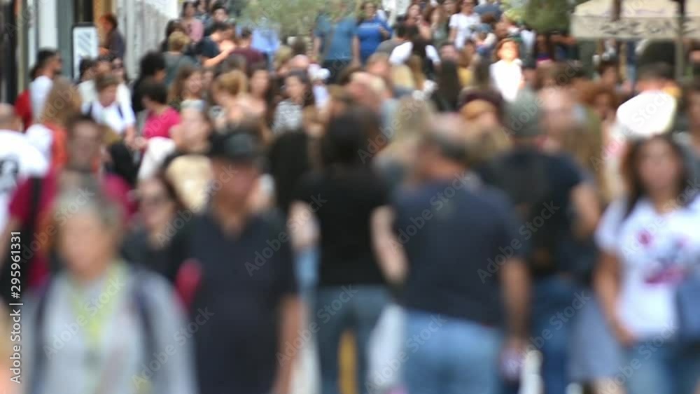 Crowd of people walking in a busy street of town Crowd of people walking in a busy street of town