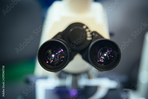 Ocular eyepiece lenses of binocular microscope, close up, selective focus