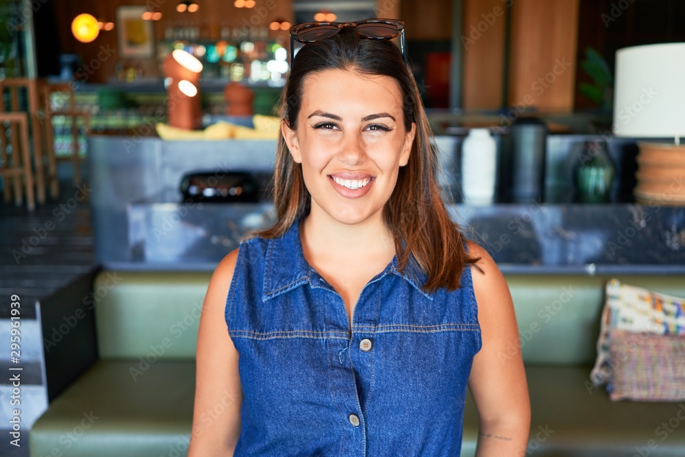 Young beautiful woman smiling happy and positive indoors of hotel resort on summer vacation Young beautiful woman smiling happy and positive indoors of hotel resort on summer vacation