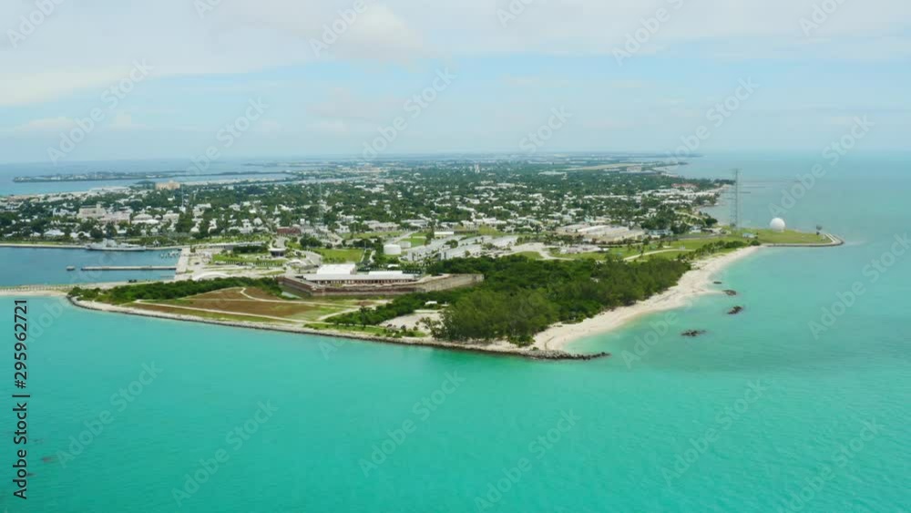 Aerial of Southernmost point of United States in Key West, paradise ocean coast of Florida, deep turquoise water, travel around US