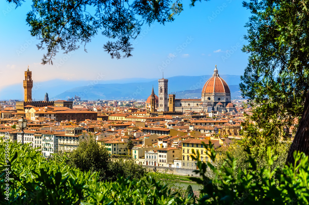 Florence, Italy: scenic view on famous italian town with Duomo at sunset with green leaves