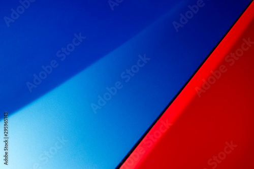 Car bodywork detail, hood and fender of sport sedan painted in blue and red colors, automobile industry, abstraction