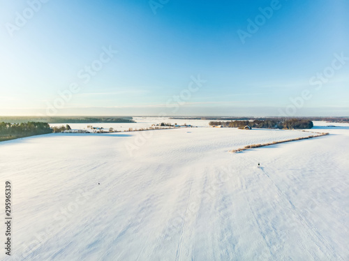 Beautiful aerial view of snow covered fields. Rime ice and hoar frost covering trees.