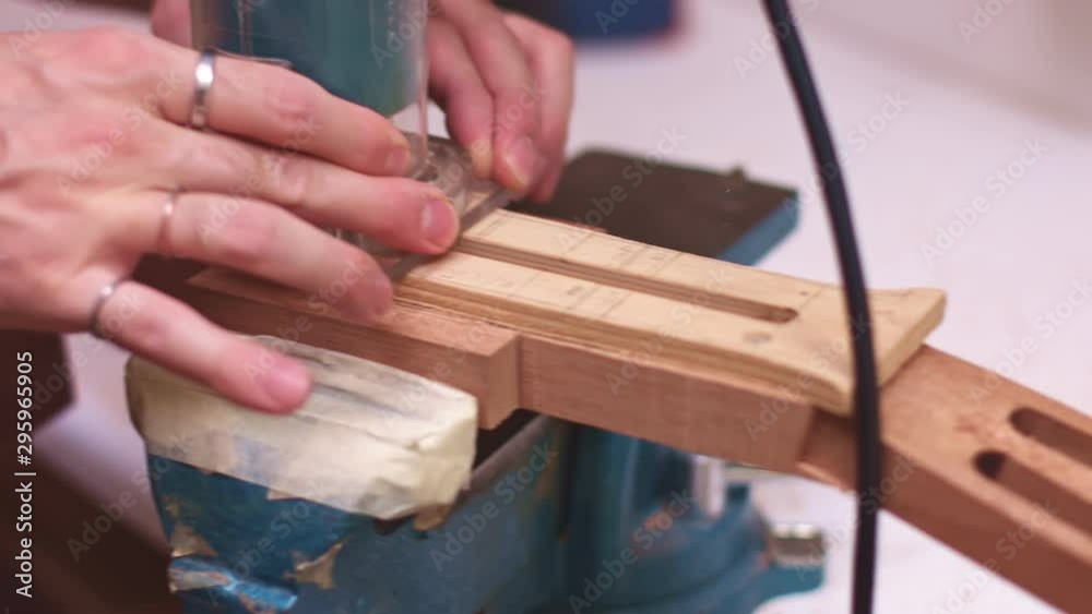 Luthier makes truss rod hole in acoustic guitar neck Luthier makes truss rod hole in acoustic guitar neck
