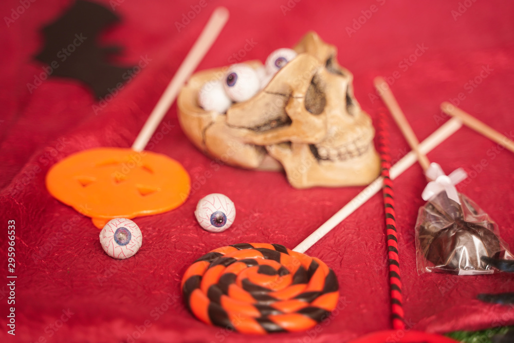 round candies in the form of eyes lie inside the open skull. Halloween home decorations for trick or treat with nobody