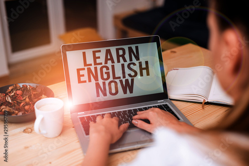 Handwriting text Learn English Now. Conceptual photo gain or acquire knowledge and skill of english language woman laptop computer smartphone mug office supplies technological devices