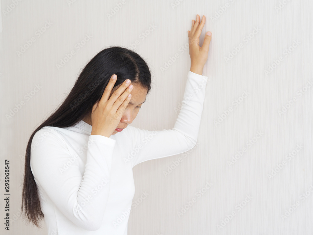 vertigo illness and sick building syndrome or SBS, brain atrophy in asian woman, She use hand touching head and felling headache dizzy sense use for health care concept. vertigo illness and sick building syndrome or SBS, brain atrophy in asian woman, She use hand touching head and felling headache dizzy sense use for health care concept.