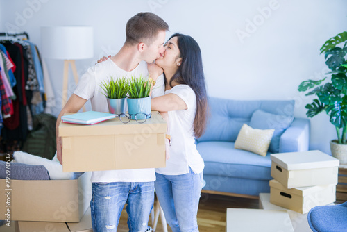 Young beautiful couple moving cardboard boxes at new home © Krakenimages.com