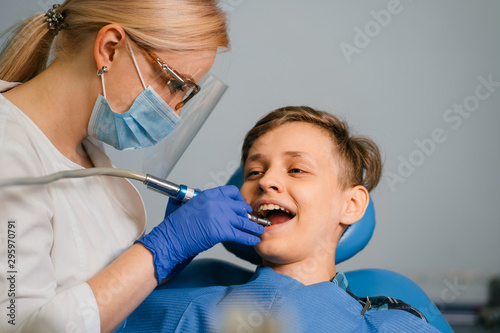 Pediatric dentistry  prevention dentistry  oral hygiene concept. Mechanical teeth cleaning  dentist at work