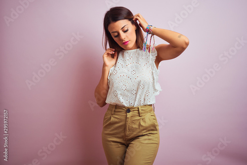 Young beautiful hispanic woman standing wearing white t-shirt