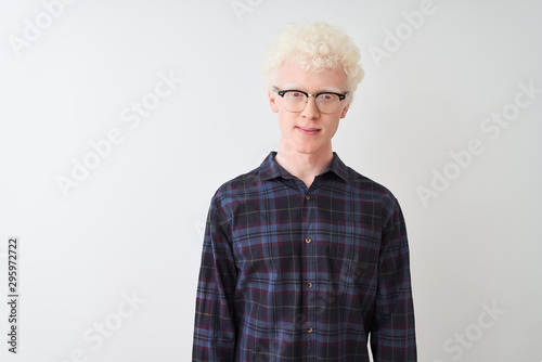 Young albino blond man wearing casual shirt and glasses over isolated white background Relaxed with serious expression on face. Simple and natural looking at the camera.