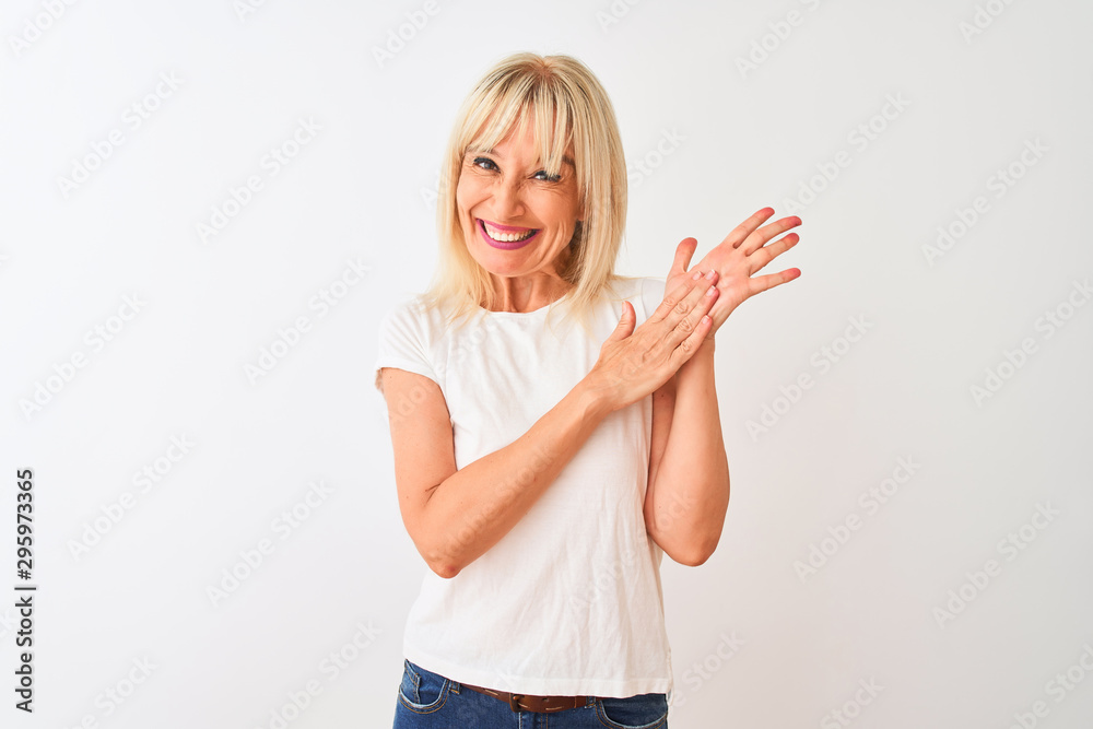 Middle age woman wearing casual t-shirt standing over isolated white background clapping and applauding happy and joyful, smiling proud hands together Middle age woman wearing casual t-shirt standing over isolated white background clapping and applauding happy and joyful, smiling proud hands together