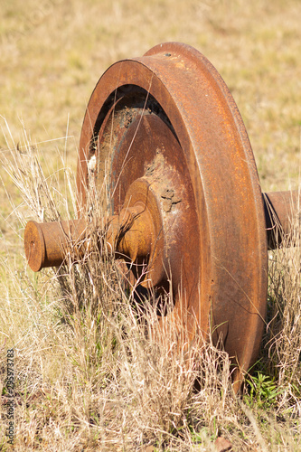 Rusty and abandoned train wheel in the countryside.