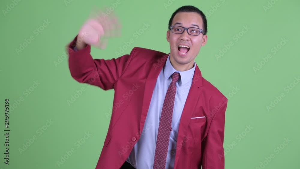 Happy Asian businessman with eyeglasses waving hand