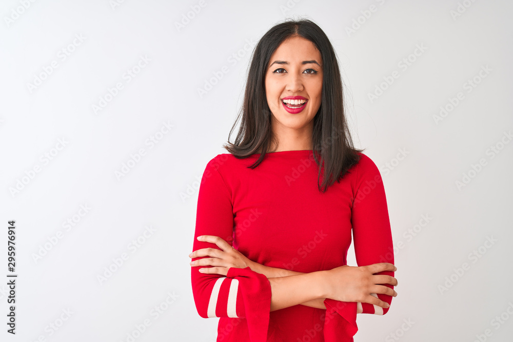 Young beautiful chinese woman wearing red dress standing over isolated white background happy face smiling with crossed arms looking at the camera. Positive person. Young beautiful chinese woman wearing red dress standing over isolated white background happy face smiling with crossed arms looking at the camera. Positive person.