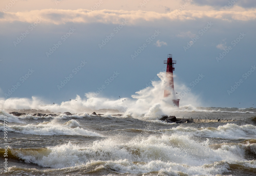 Waves crashing over lighthouse