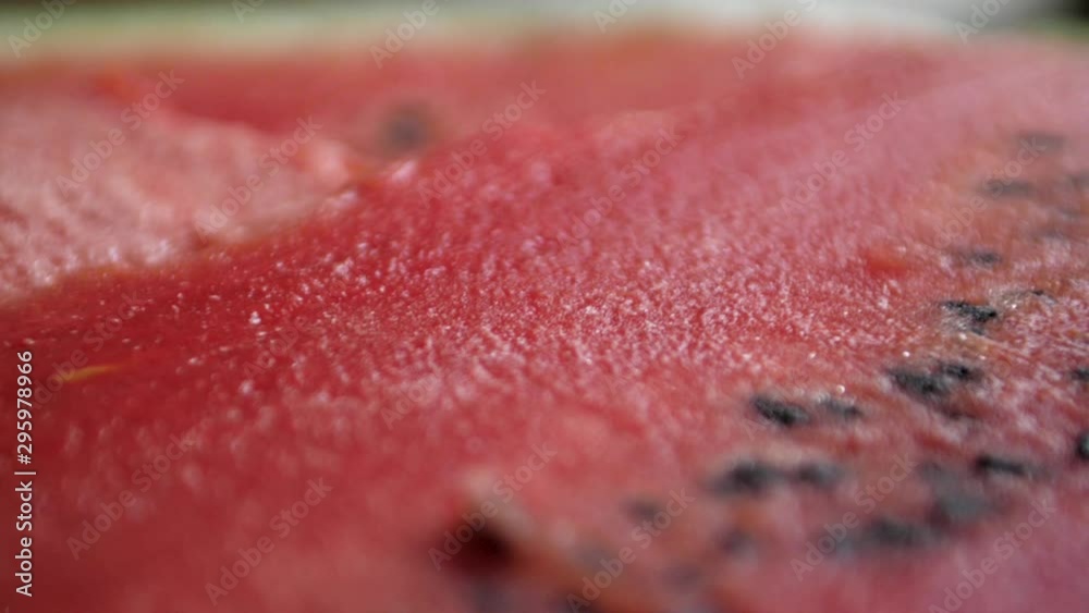 Macro dolly shot over the top of a freshly sliced watermelon
