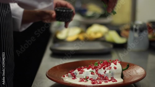 chef preparing chile en nogada, mexican traditional dish photo