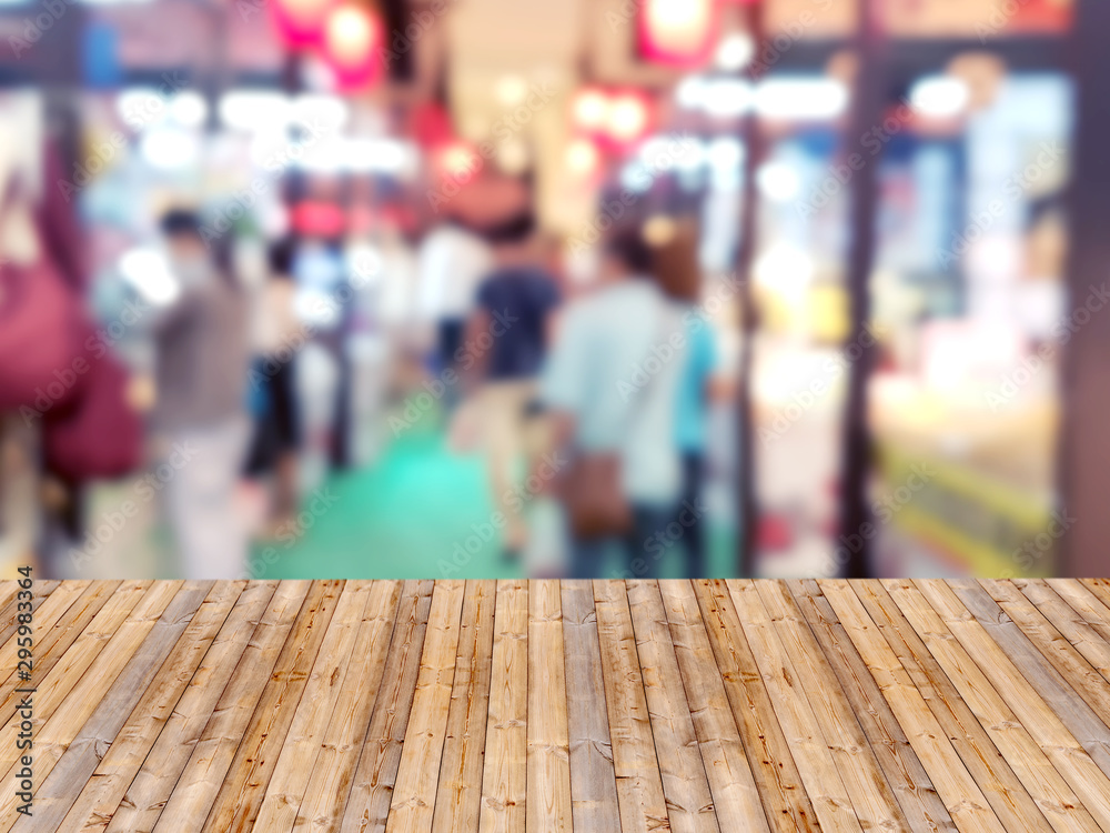 Wooden table with shopping mall blurred background Wooden table with shopping mall blurred background