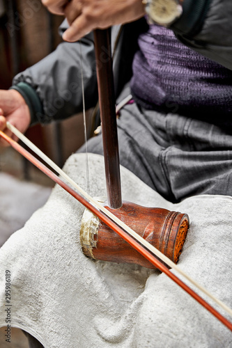 San Francisco, California, USA - December 15, 2018: Man playing Erhu, traditional Chinese violin, in Chinatown. photo