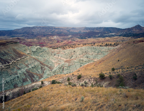Breathtaking views of the grey-blue badlands and the scenic John Day River Valley and Mountains from the rustic Blue Basin Overlook Trail at the John Day Fossil Beds Sheep Rock Unit in Kimberly Oregon