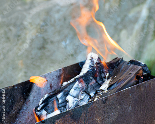 Fire and smoke. Barbecue firewood. Grill for frying meat. Bonfire on a picnic. Hot coals..