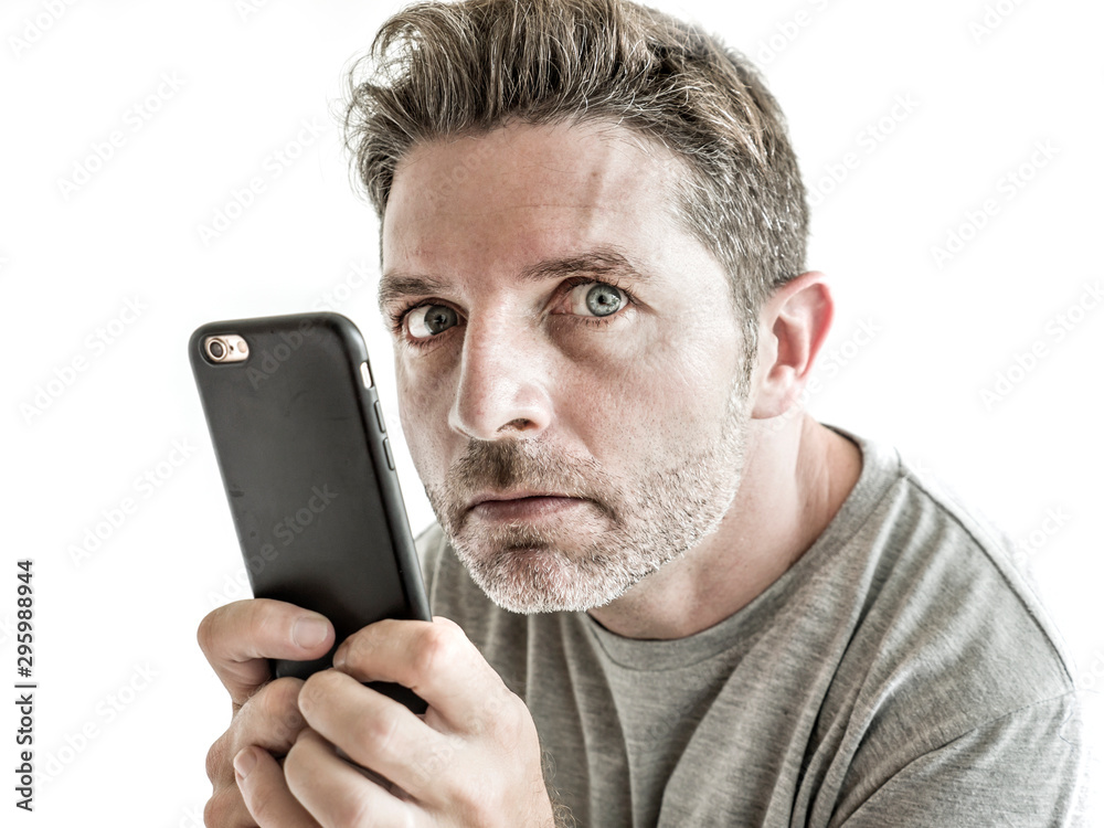 freak and weird looking man using mobile phone watching something online in sick intense face expression in internet and social media addiction concept isolated - obrazy, fototapety, plakaty 