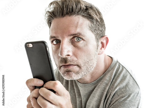 Fotografija freak and weird looking man using mobile phone watching something online in sick