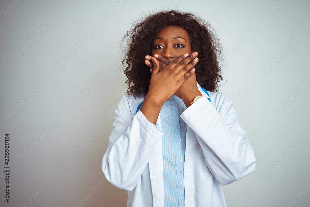 Young african american doctor woman wearing stethoscope over isolated white background shocked covering mouth with hands for mistake. Secret concept. Young african american doctor woman wearing stethoscope over isolated white background shocked covering mouth with hands for mistake. Secret concept.